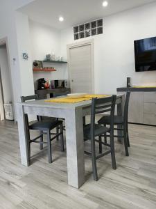 a kitchen with a table and some chairs around it at Il Tramonto - BALESTRATE in Balestrate