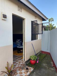 a house with a door open to a patio at Maasaifari Osmlai in Arusha