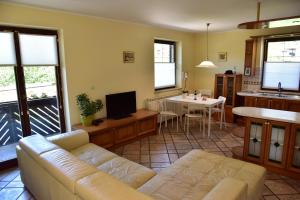a living room with a couch and a kitchen at Apartment JANG in Tolmin