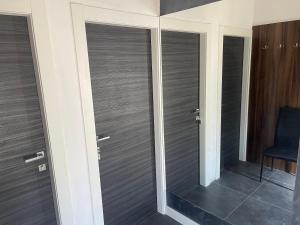 a room with two sliding glass doors with a chair at Mediteraneo in Dubrovnik +3 photos