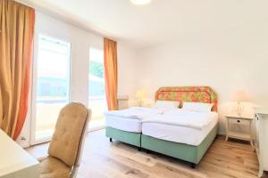 a bedroom with a bed and a large window at renoviertes Reihenhaus am Radweg in Lignano in Bevazzana