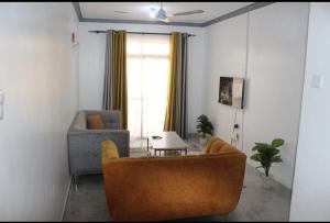 a living room with a couch and a table at Floviol home in Mombasa