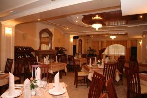a dining room with tables and chairs in a restaurant at Duet Plus in Uzhhorod