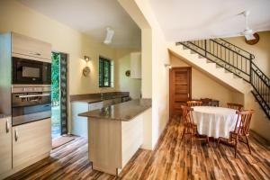a kitchen and dining room with a table and chairs at Beach Bliss Bungalow in Rivière Noire
