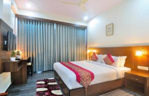 a hotel room with a large bed and a window at Airport hotel deep palace near international airport in New Delhi