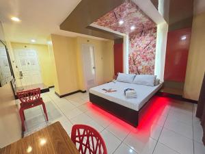 a room with a bed and a table and chairs at Hotel Sogo Sta Rosa in Santa Rosa