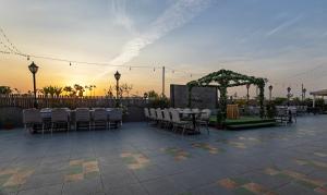 an outdoor patio with tables and chairs and a wedding at Treebo Trend Eden Park, Ahmedabad in Ahmedabad