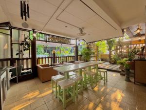 a restaurant with a table and chairs in a room at Baan Baramee House in Chiang Rai