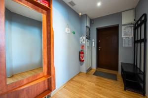 a hallway with a door and a mirror on the wall at Apartament MonteCassino in Szczecin