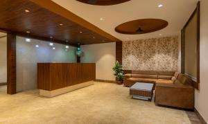 a lobby with a couch and a podium at Treebo Trend Eden Park, Ahmedabad in Ahmedabad