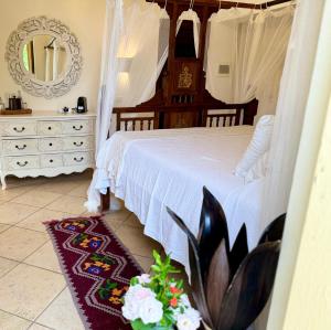 a bedroom with a bed and a dresser with a mirror at Terre Di Vendicari in Noto