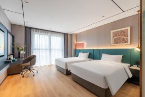 Voodi või voodid majutusasutuse CheerMay Hotel - Beijing Conference Center toas