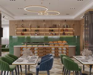 a restaurant with two tables and green chairs at Hotel 1946 in Tashkent