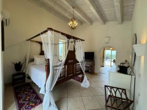 a bedroom with a bed with a canopy at Terre Di Vendicari in Noto