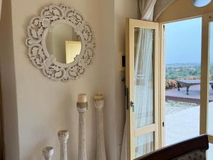 a mirror on a wall next to a door at Terre Di Vendicari in Noto
