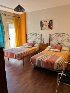 deux lits dans une chambre avec parquet dans l'établissement La Huella del Cuero, à Siles