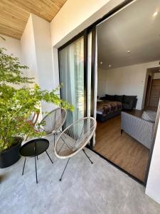 a living room with two chairs and a couch at Hotel Homey Kobuleti in K'obulet'i