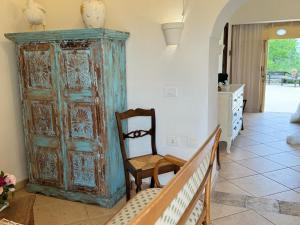 a room with an old wooden cabinet and a chair at Terre Di Vendicari in Noto