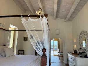 a bedroom with a bed with a canopy at Terre Di Vendicari in Noto
