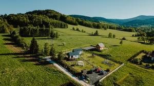 an aerial view of a house in the middle of a field at Sarnia Łąka house with private outdoor jacuzzi - child-friendly - pets allowed in Stronie Śląskie
