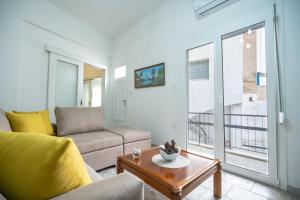 a living room with a couch and a table at Keratsini 2 bedroom 4 pers apart by MPS in Piraeus
