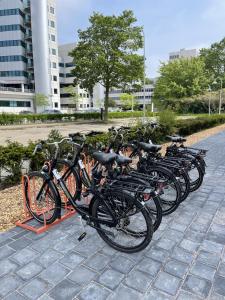 a row of bikes parked next to each other at OZO Hotels Antares Amsterdam Schiphol Airport in Hoofddorp