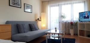 a living room with a couch and a table at Haus Abendsonne Obergeschoss klein in Koblenz