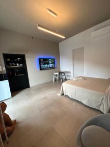 a bedroom with a bed and a table and chairs at MP Luxury room in Budoni