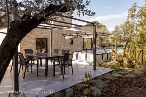 eine Holzterrasse mit einem Tisch und Stühlen darauf in der Unterkunft villa allegria in Foligno