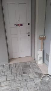 a white door in a room with a tile floor at white house 1492..il sogno continua.. in Brescia