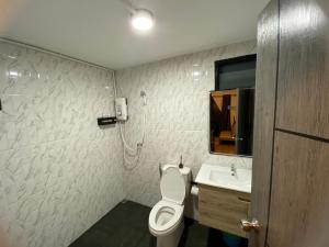 a bathroom with a toilet and a sink at Freedom home khaokho in Khao Kho