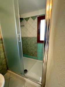 a shower with a glass door in a bathroom at Casa Giliè A in Santa Maria Navarrese
