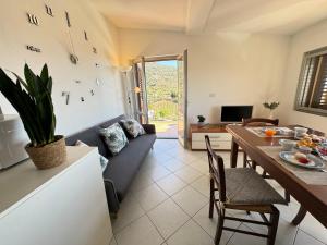 a living room with a couch and a table at Casa Giliè A in Santa Maria Navarrese