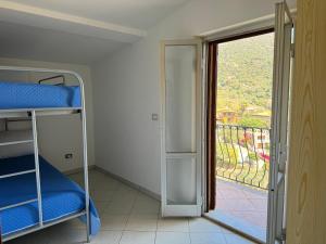 a room with a bunk bed and a door to a balcony at Casa Giliè A in Santa Maria Navarrese