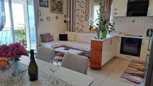 a living room with a couch and a table at Apartment Roberta in Lovran +37 photos