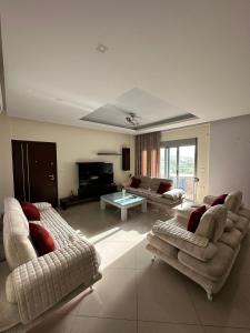 a large living room with two couches and a tv at Villa Nefeli Ksamil in Ksamil