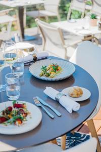 Hôtel La Villa Douce في لو رايول-كاناديل-سور-مير: طاولة زرقاء مع أطباق من الطعام عليها