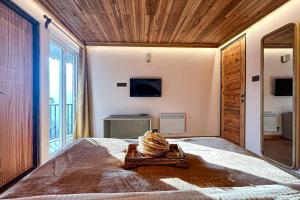 a bedroom with a large bed with a large window at Himalayan Hues in Gangtok
