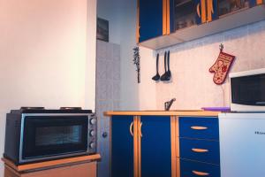 a kitchen with a microwave and a counter with a tv at Apartments Branko Zadar in Zadar