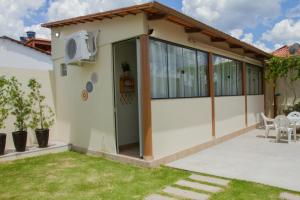 a house with a large glass door and a patio at Studio Aconchego Correntina in Correntina