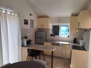 a small kitchen with a table and a microwave at Pension Oaza in Hvar