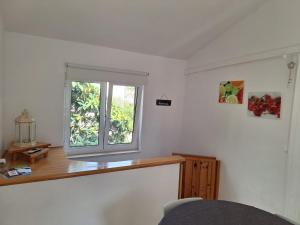 a room with a window and a wooden counter at Pension Oaza in Hvar