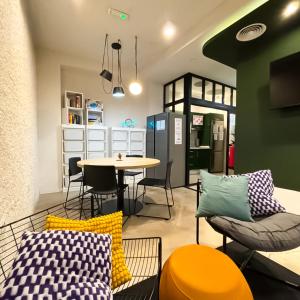 a living room with a table and chairs and a table at Atypicap Capsule Hostel in Puerto de la Cruz