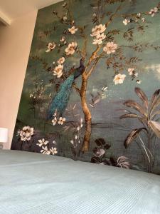 a painting of a blue bird on a tree with flowers at Villa Mirabelle 4 personnes in Châteauneuf-de-Gadagne