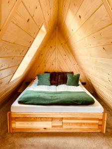 a bed in a wooden room in a tree house at Domek Turniczka in Szaflary