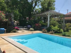 a swimming pool in a yard with a gazebo at Casa Oliva-Casa da Eira in Porto de Mós