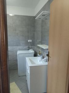 a bathroom with a sink and a toilet at ApartmanA&J1111 in Kaštela +7 photos