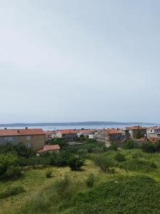 a view of a city with the ocean in the background at ApartmanA&J1111 in Kaštela