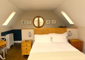 een slaapkamer met een groot bed en een spiegel bij The Loft at the Croft - Stunning rural retreat perfect for couples & dogs in Leigh
