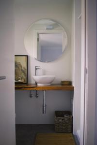 a bathroom with a sink and a mirror at Casa Oliva - Casa da Lenha in Porto de Mós